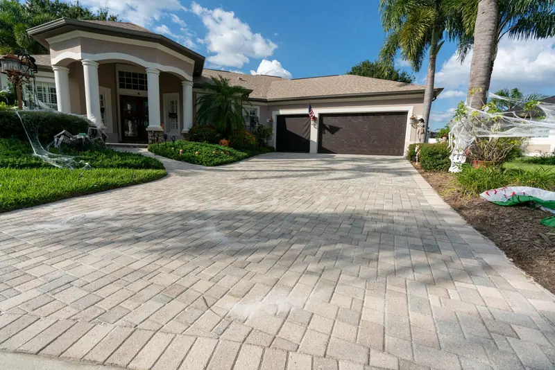 A sealed paver driveway leading to a two-car garage