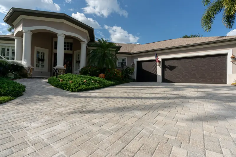 A sealed paver driveway in front of a home
