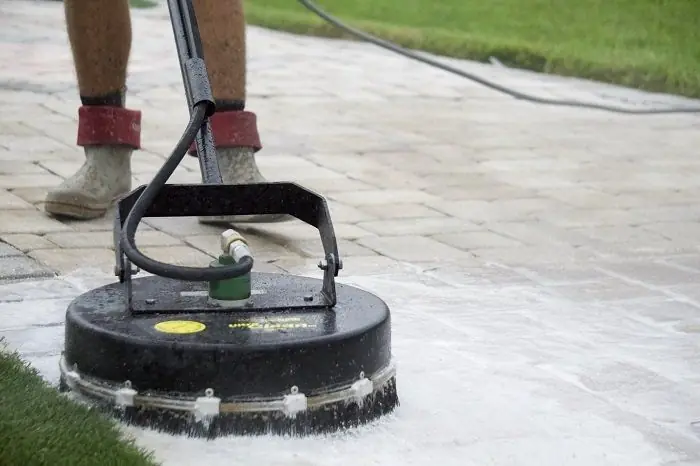 A surface cleaner running over pavers